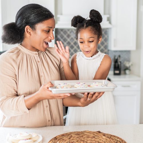 woman bakes cookies with daughter